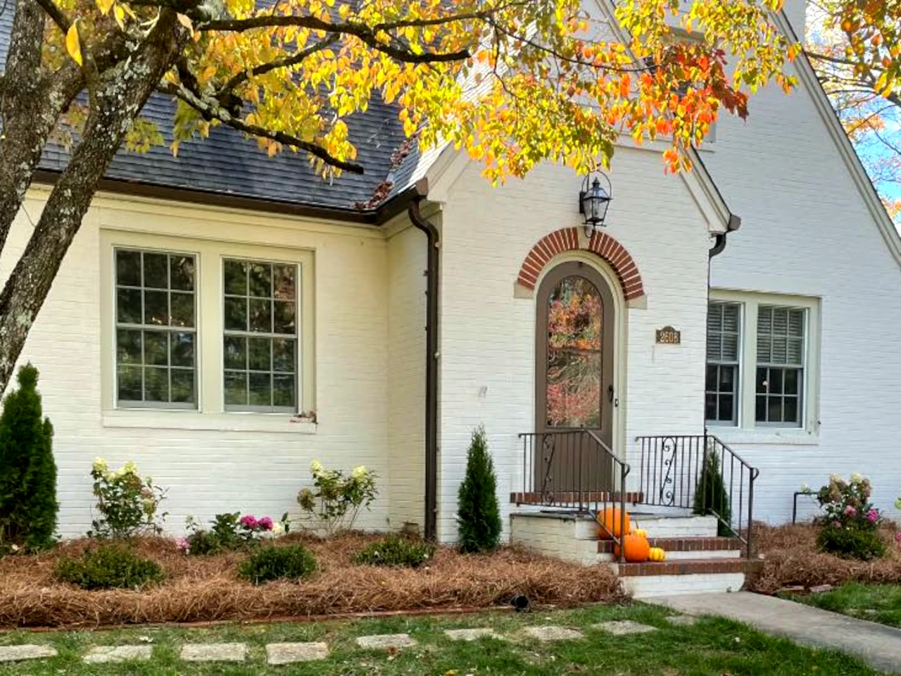 Autumn landscape design with seasonal flowers and pumpkins at a Winston-Salem residence by GH Cutting Edge