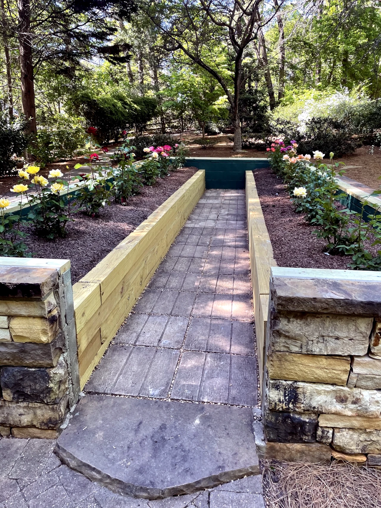 Elegant raised bed rose garden with stone walkway in Winston-Salem, NC, designed by GH Cutting Edge Hardscapes