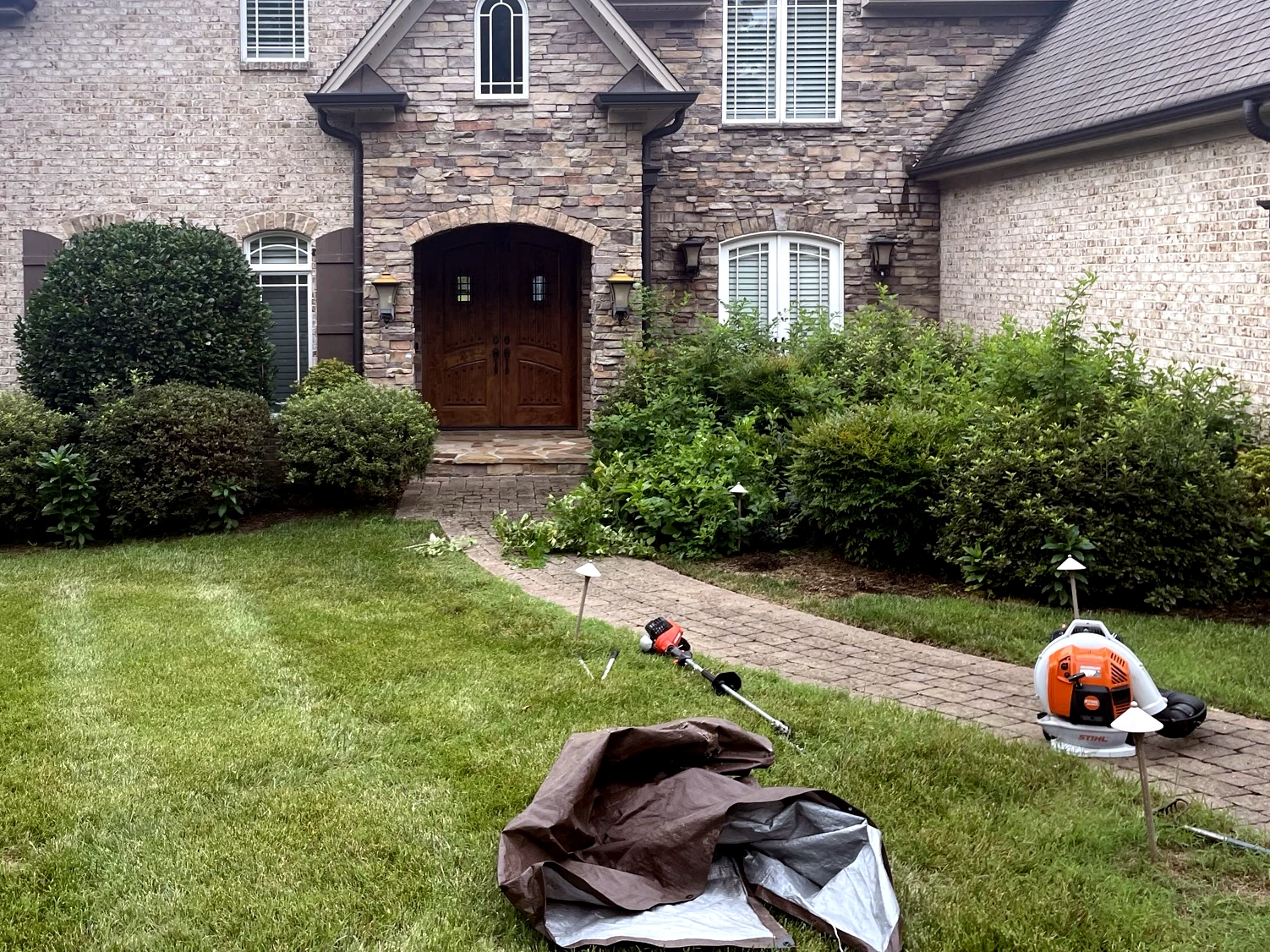 Ongoing landscape maintenance at a Winston-Salem residence with professional equipment by GH Cutting Edge