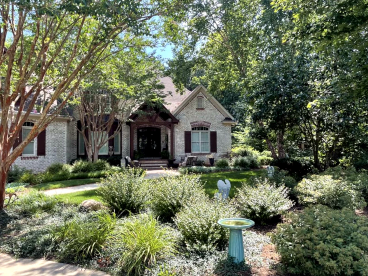 Elegant residential landscape design with lush greenery and mature trees in Winston-Salem, NC by GH Cutting Edge