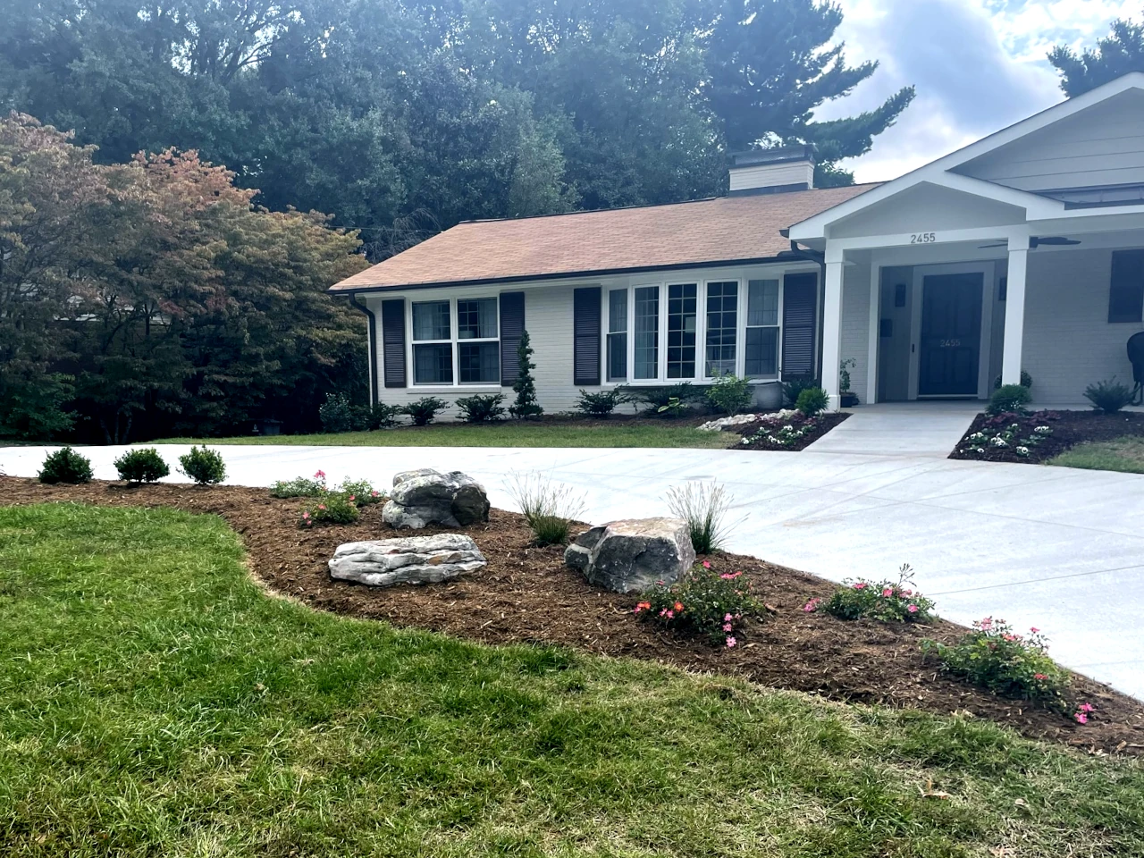 Residential landscape enhancement with newly installed plants and decorative rocks in Winston-Salem, NC by GH Cutting Edge