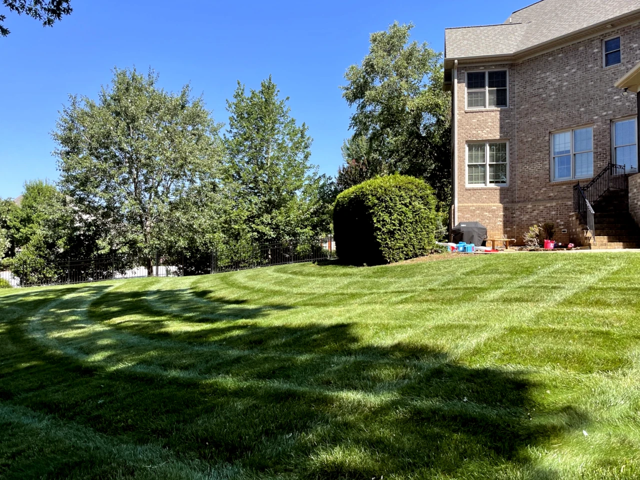 Premium lawn care with precise mowing patterns at a Winston-Salem residence by GH Cutting Edge Lawn Mowing Services